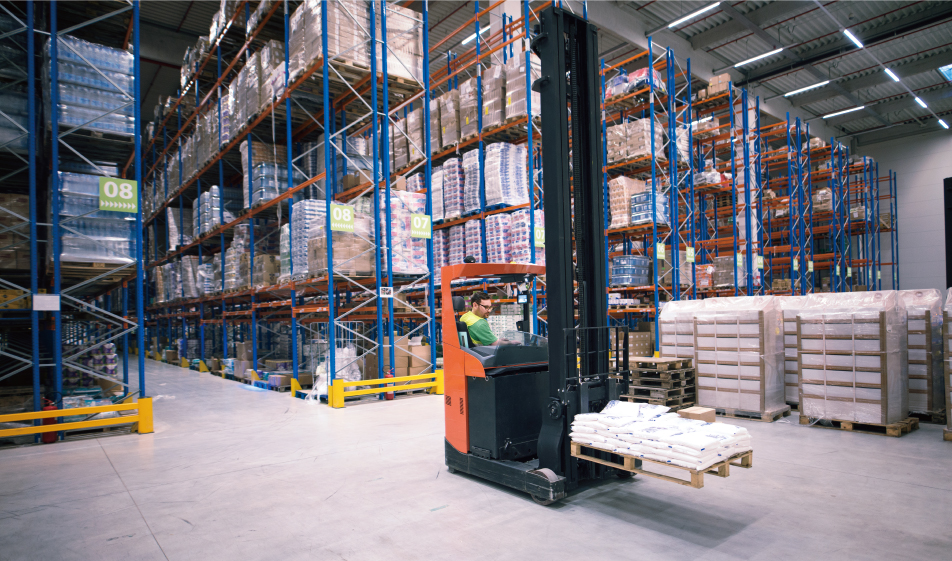 An Imange Showing A male forklift operator picking up the goods on pallet